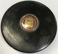 A 19th Century circular tortoiseshell box with yellow metal and enameled medallion inscribed "Don