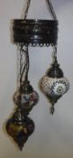 A metal mounted and mosaic and beadwork embellished triple pendant ceiling light in the Moorish