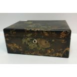 A Victorian black lacquered and gilt decorated and painted work box of rectangular form decorated