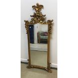 A modern gilt framed wall mirror in the Rococo taste with scrolling foliate decoration, 62.