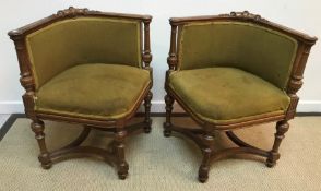 A pair of Edwardian beech show framed corner chairs with shaped stretcher,