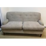 A modern mushroom or taupe upholstered two seat sofa in the Howard manner,