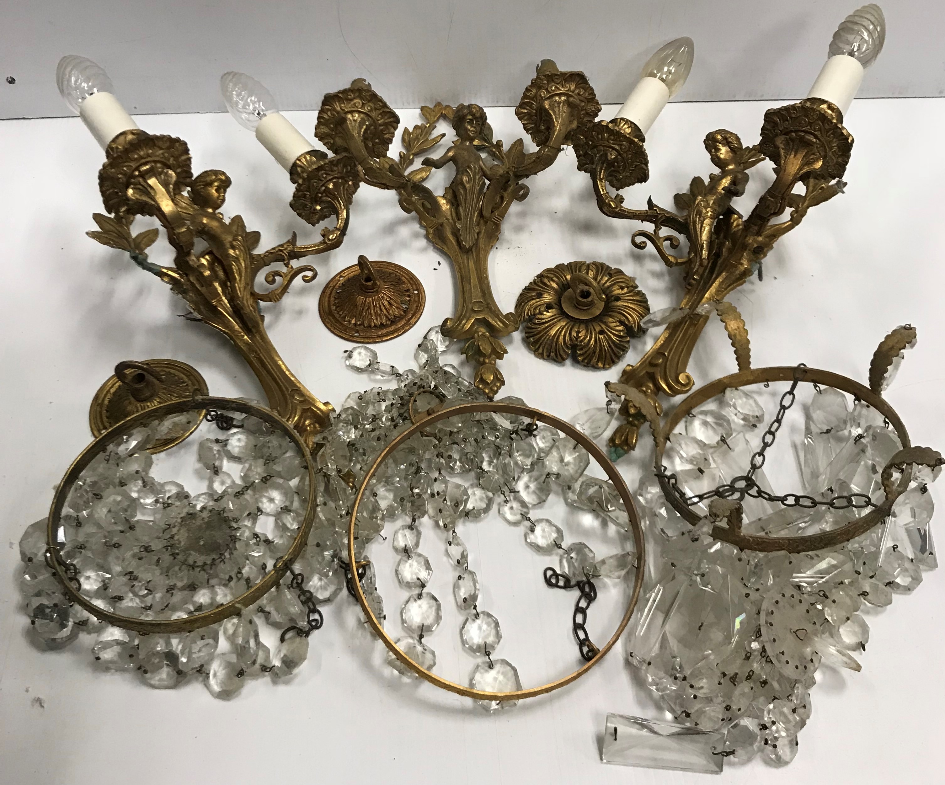 A pair of 20th Century brass wall lights as putti and scrolling foliage 33.