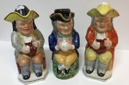 Three 19th Century pottery Toby jugs and covers as "Toby Philpott seated with jug of ale",