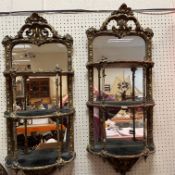 A pair of 18th Century giltwood and gesso framed three tier mirrored wall shelves with open