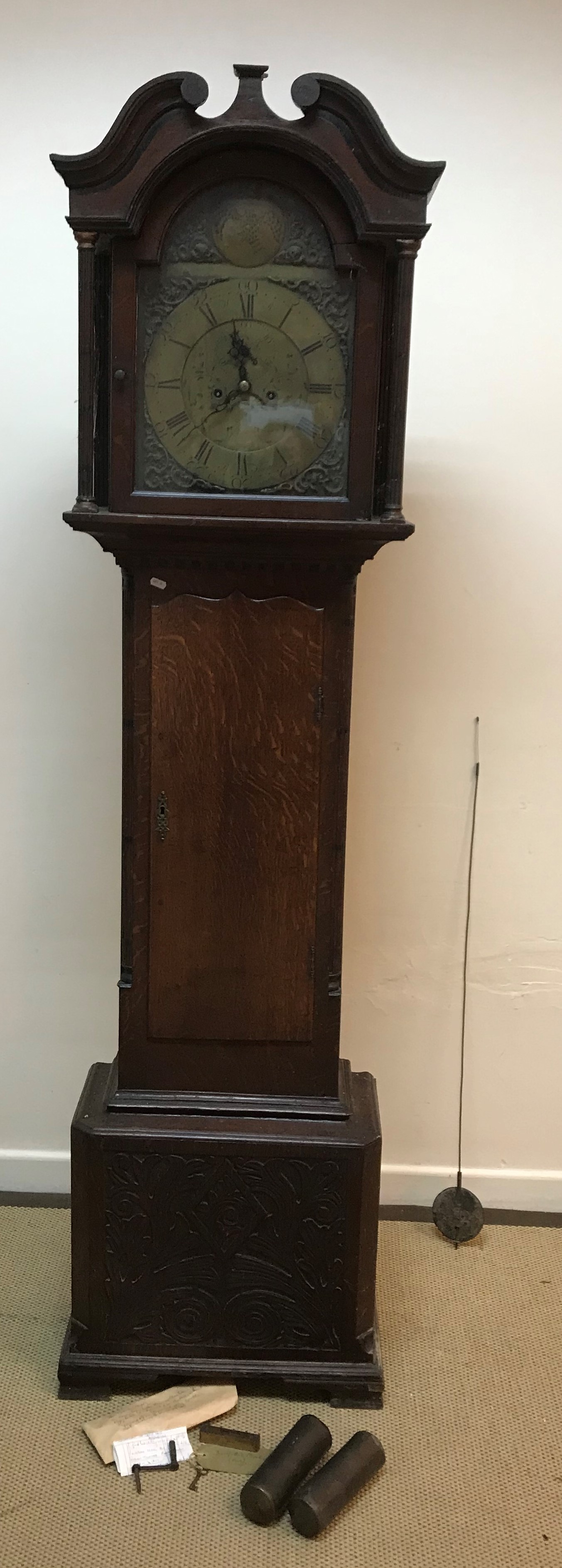 A George III oak and inlaid cased long case clock, the hood with broken arch pediment,