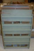 A collection of fourteen folding beech shelf units, eight painted, six in the wood,