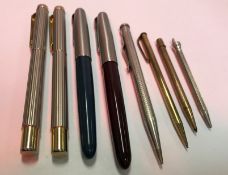 A collection of pens to include two Parker fountain pens, a silver plated propelling pencil,
