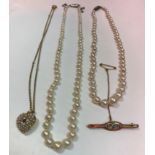 Two single strand pearl necklaces,