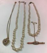 Two single strand pearl necklaces,