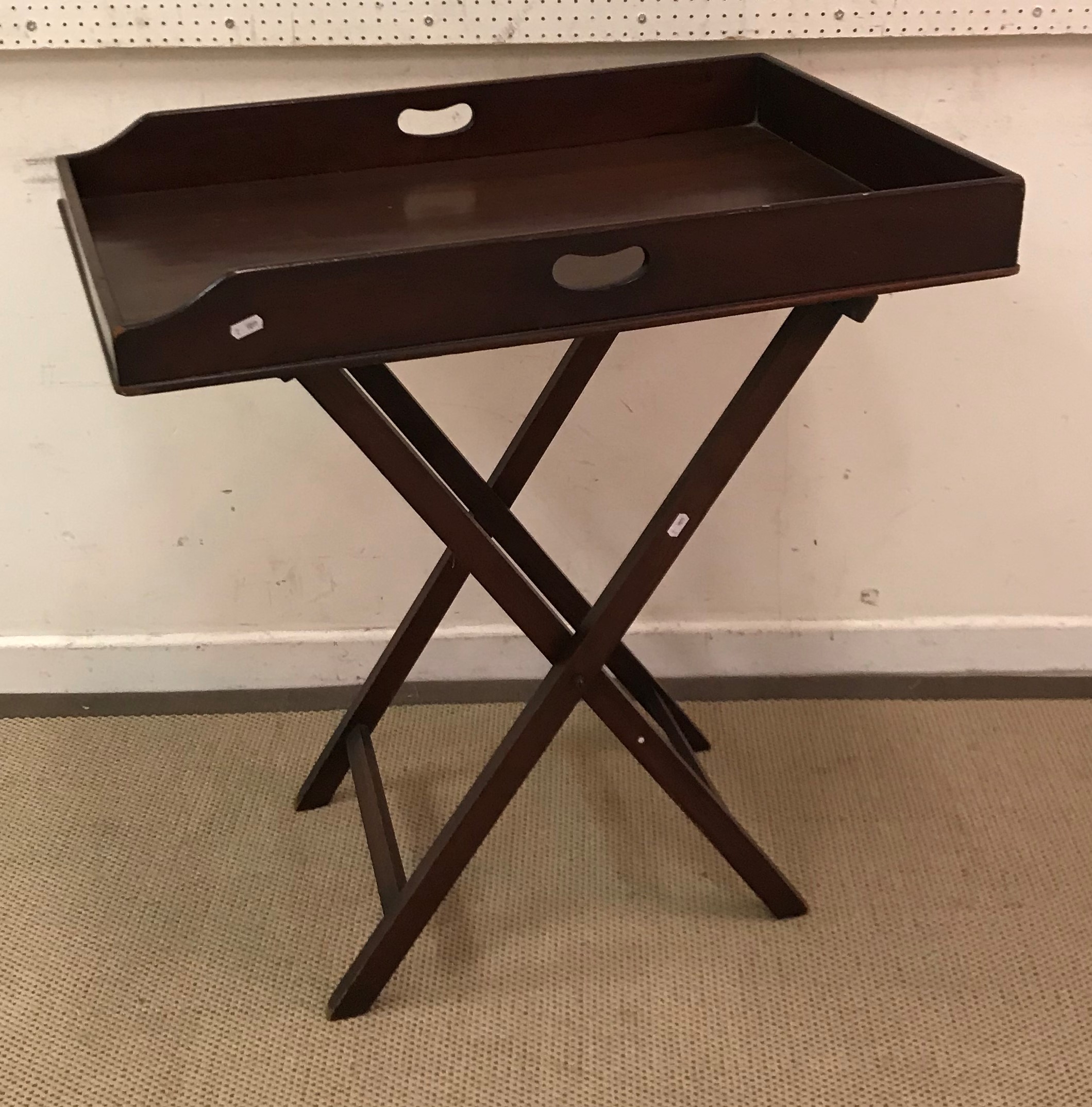 A 19th Century mahogany butler's tray of plain rectangular form, raised on a plain folding stand,