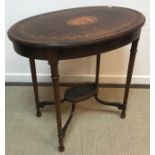 A mahogany and inlaid oval centre table on turned legs united by a brass galleried undertier, 78.