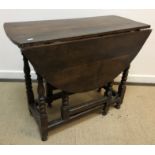 An 18th Century and later oak oval gate-leg drop-leaf dining table on turned supports to block feet