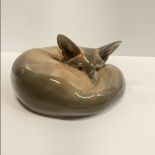 A Royal Copenhagen fox curled up (No. 438) 17 cm long x 8 cm high approx.