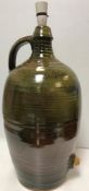 A Winchcombe Pottery ochre/brown glazed flagon now as a table lamp (tap missing) 51 cm high (not