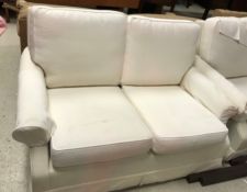 A Wesley Barrell cream ground two seat scroll arm sofa,