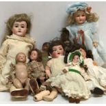 A collection of various early 20th Century porcelain headed and other dolls including an Armand