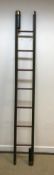 A brass studded green leather covered library ladder in the 19th Century manner with mahogany rungs,