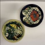 A Moorcroft plate with tube-lined decoration of a poppy, circa 1996, 26 cm diameter,