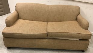 A modern fawn upholstered two seat sofa bed,