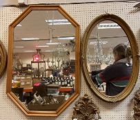 A gilt framed oval wall mirror with floral spray decoration,