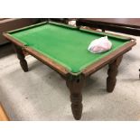 An EJ Riley quarter size snooker table of child's proportions, raised on turned legs,