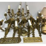 A set of six 20th Century brass twin light wall sconces on flaming torch / urn supports,