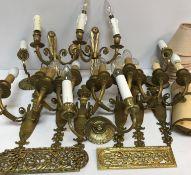 A set of six 20th Century brass twin light wall sconces on flaming torch / urn supports,