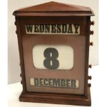 A late Victorian mahogany cased perpetual desk calendar of architectural form 22 cm wide x 30 cm