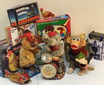 A box of various vintage toys and games to include a Cragstan crapshooter monkey clockwork toy,