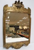 An 18th Century carved giltwood and gesso framed wall mirror,