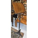 A Victorian cast iron adjustable music stand with walnut book rest