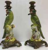 A modern pair of pottery and brass "Parrot" candlesticks bearing printed mark to base of crowned