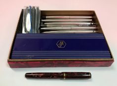 A collection of various pens including a Burnham brown marbleised and gold mounted fountain pen,
