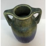 A Ruskin pottery blue/green glazed two handled urn vase, 24.