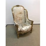 A 19th Century carved giltwood and gesso framed wing back elbow chair in the Louis XVI taste with