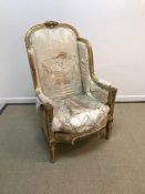 A 19th Century carved giltwood and gesso framed wing back elbow chair in the Louis XVI taste with