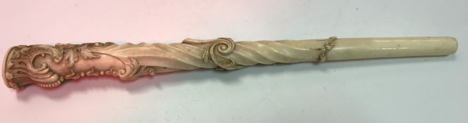 A circa 1900 ivory parasol handle with carved acanthus leaf and scrolling decoration with gilt