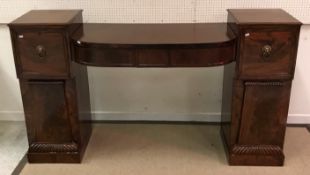 A Regency mahogany pedestal sideboard with central bow fronted three drawer section flanked by