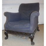 A Victorian upholstered scroll arm chair with blind fretwork carved and gadrooned seat rails on