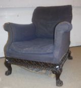 A Victorian upholstered scroll arm chair with blind fretwork carved and gadrooned seat rails on