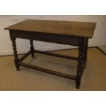 An 18th Century oak side table, the plank top above a plain frieze with moulded base,