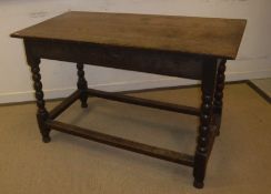 An 18th Century oak side table, the plank top above a plain frieze with moulded base,