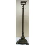 A circa 1900 brass oil lamp standard on a reeded column to tri-form reeded base and circular feet,