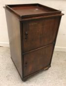 A mahogany and cross-banded side table with dummy drawer and brushing slide on square tapered legs,