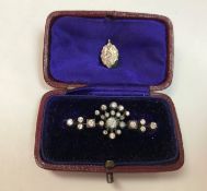 A diamond set bar brooch set with twenty-four varying sized diamonds and a diamond set