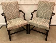 A pair of early 20th Century mahogany framed open arm chairs in the Chippendale Revival taste,