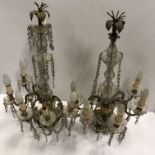 A pair of early 20th Century gilt brass and cut glass table lights each with central column and