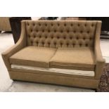 A modern buttoned upholstered two seat sofa bed in fawn upholstery,