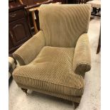 A modern upholstered armchair in the Victorian manner in fawn and black striped upholstery,